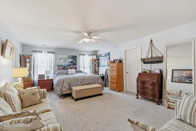 a spacious bedroom with a bed and furniture