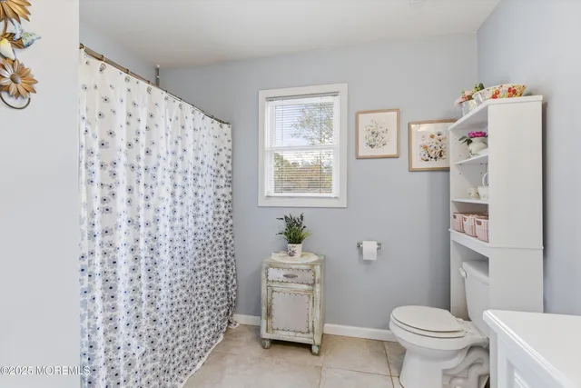 a white toilet sitting next to a bathroom sink