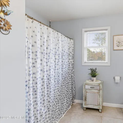 a bathroom with a sink a toilet and a window