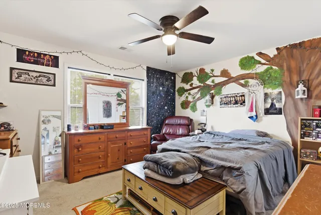 a bedroom with a bed dresser and a window