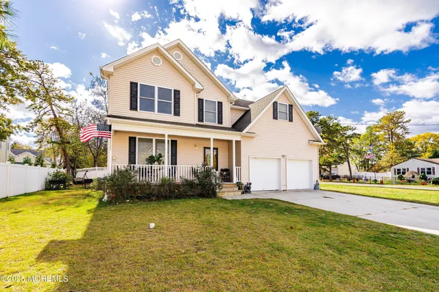 a front view of a house with swimming pool and glass windows