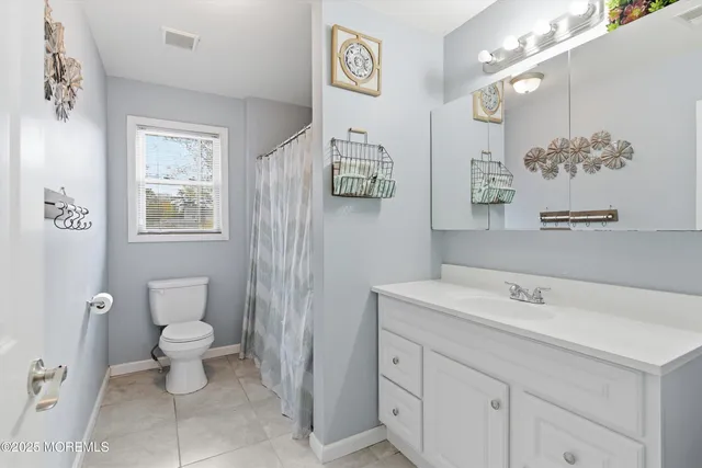 a bathroom with a sink mirror and toilet