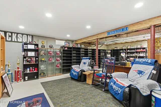 a living room with lots of furniture and a book shelf