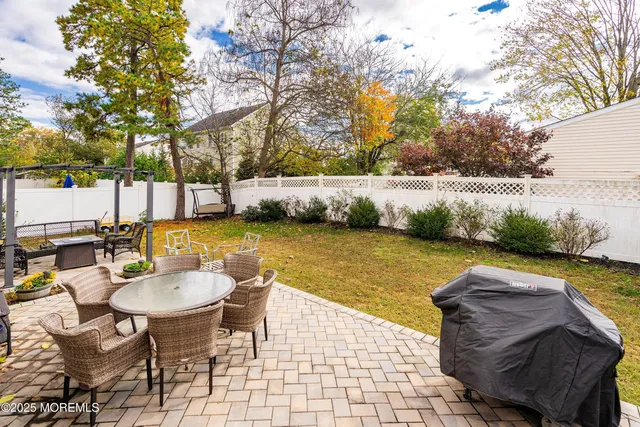 a view of a lake with a table and chairs