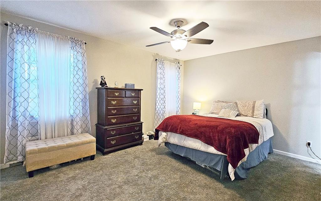 2825 Northeast Expressway, Unit E2 Atlanta, GA 30345 - Photo 5 of 15 a spacious bedroom with a bed and a chandelier
