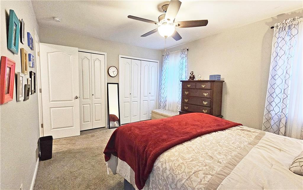 2825 Northeast Expressway, Unit E2 Atlanta, GA 30345 - Photo 6 of 15 a bedroom with a bed and a chandelier