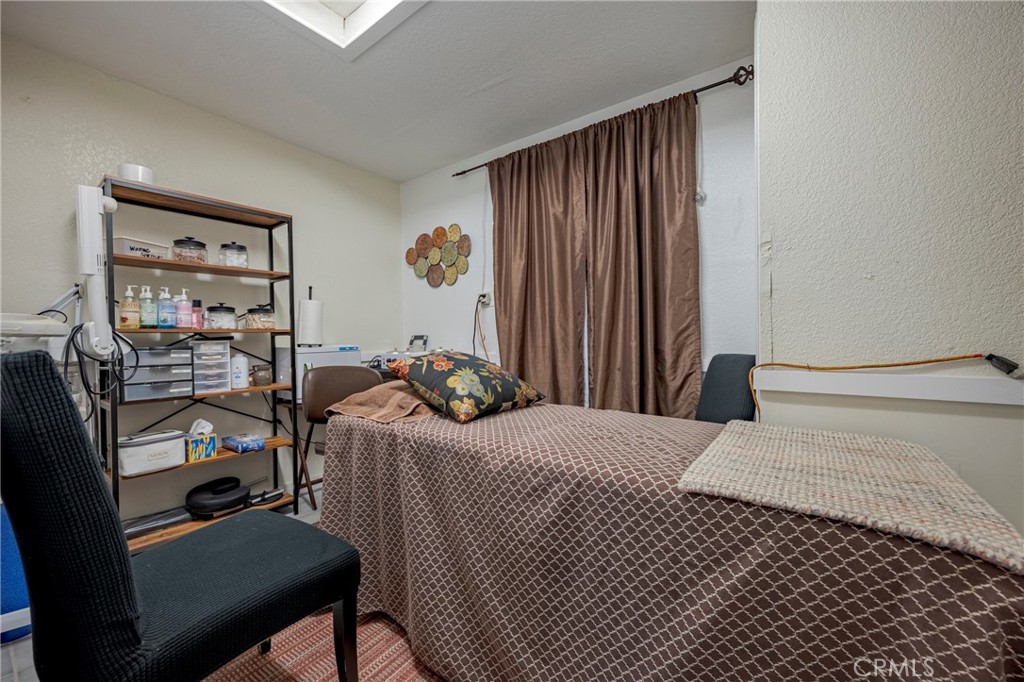 9387 Broadway Planada, CA 95365 - Photo 18 of 31 a bedroom with a bed and a table