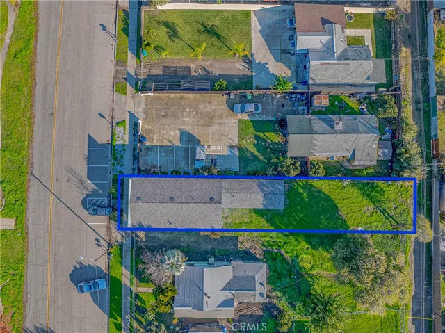 an aerial view of a house with a yard and a large pool