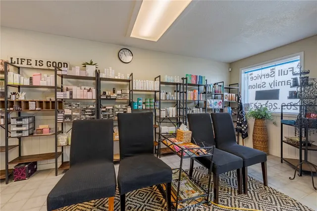 a living room with lots of furniture and a view of kitchen