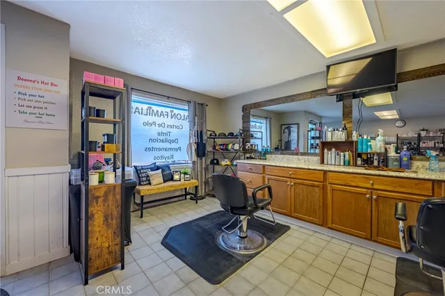 a room with table chairs and wooden floor