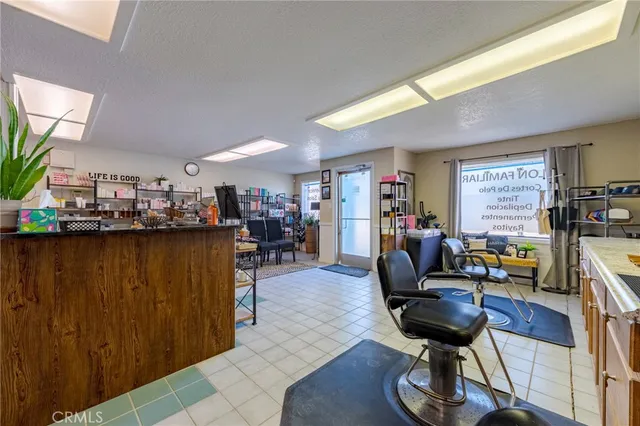 a living room with lots of furniture and clutter