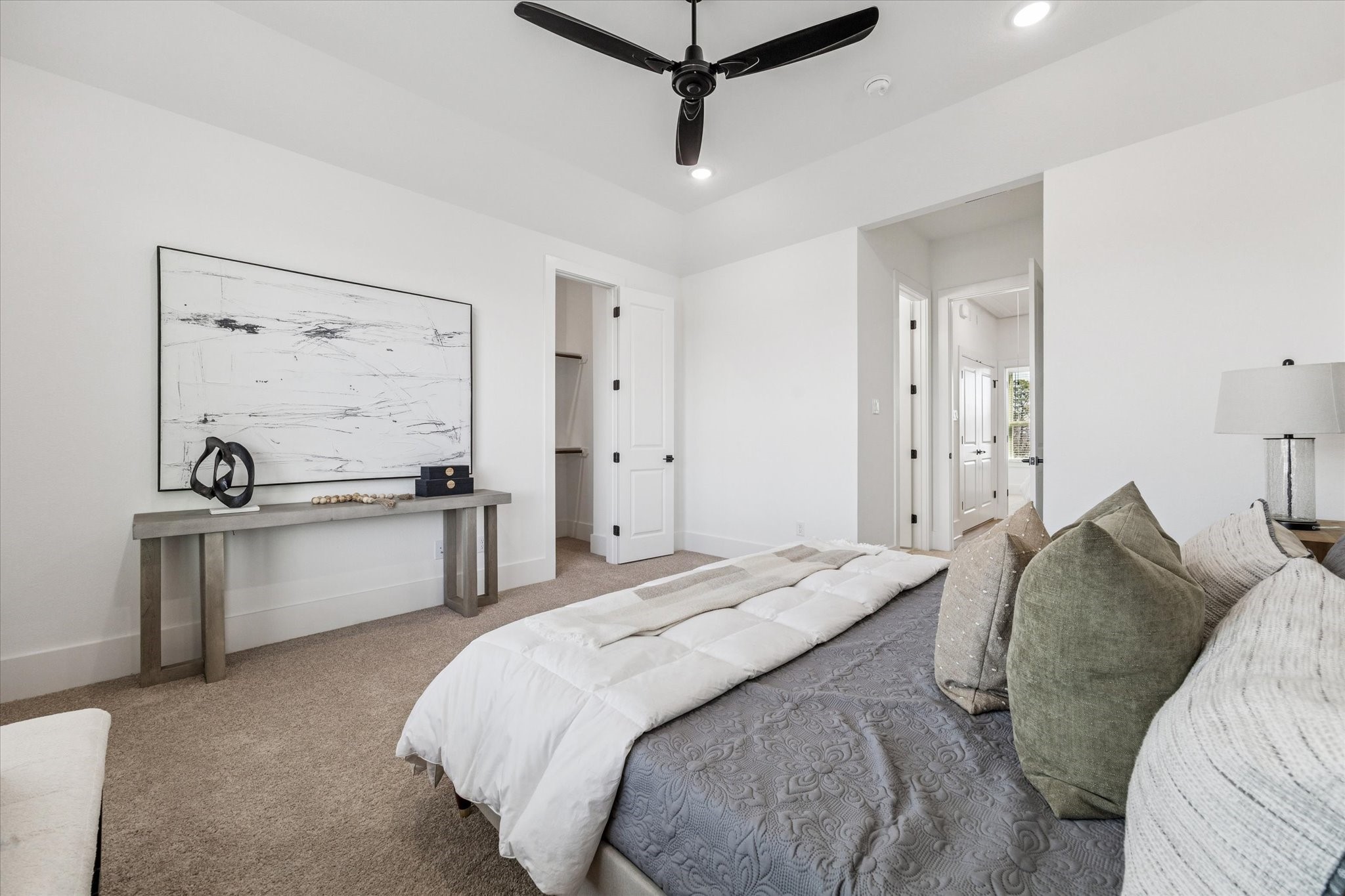5633 Azores Houston, TX 77091 - Photo 24 of 38 a spacious bedroom with a bed and ceiling fan