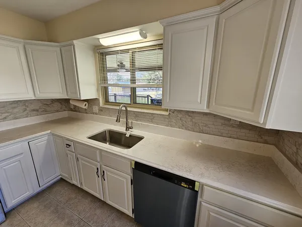 a kitchen with a sink and cabinets