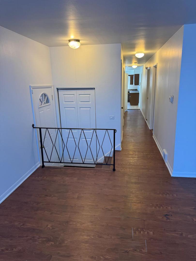 39 West 83rd Street Chicago, IL 60620 - Photo 3 of 12 a view of a hallway with wooden floor
