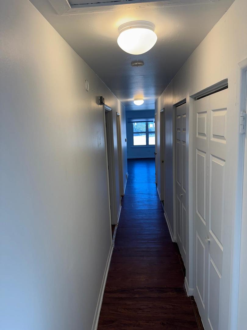 39 West 83rd Street Chicago, IL 60620 - Photo 4 of 12 a view of a hallway with wooden floor and a chandelier