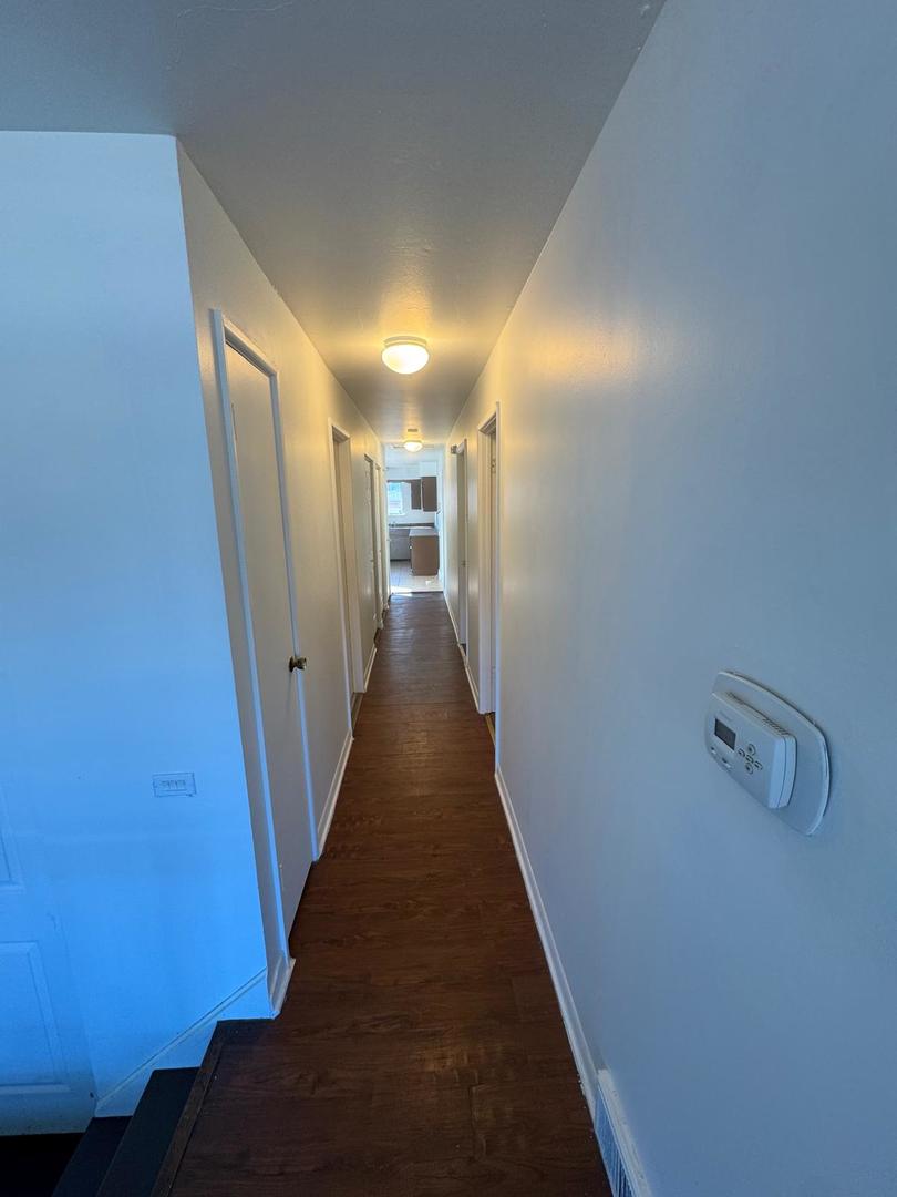 39 West 83rd Street Chicago, IL 60620 - Photo 9 of 12 a view of a hallway with wooden floor