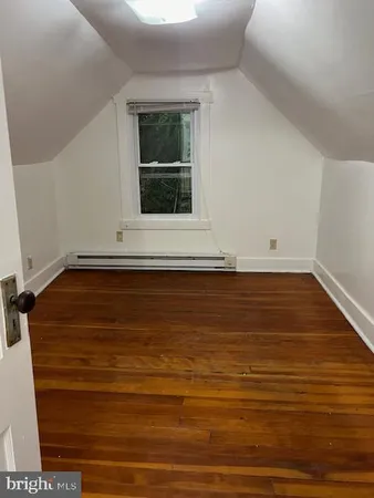 a view of room with window and hardwood floor