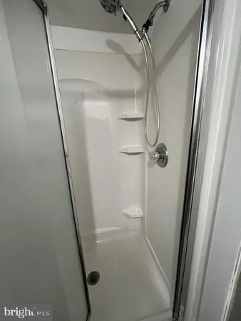 a bathroom with a glass shower door