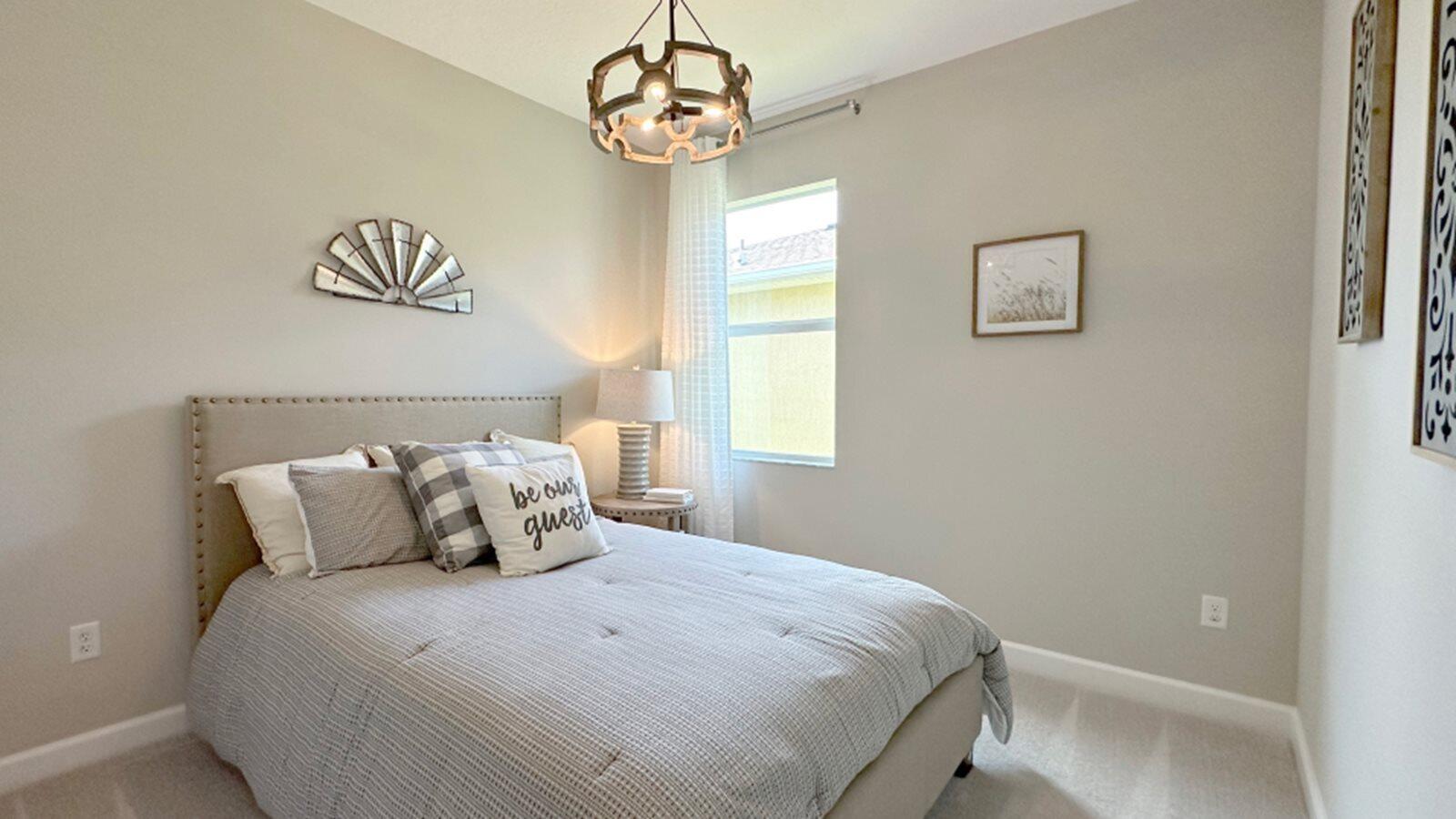 3611 Angler Drive Fort Pierce, FL 34946 - Photo 7 of 13 a bedroom with a bed and a chandelier