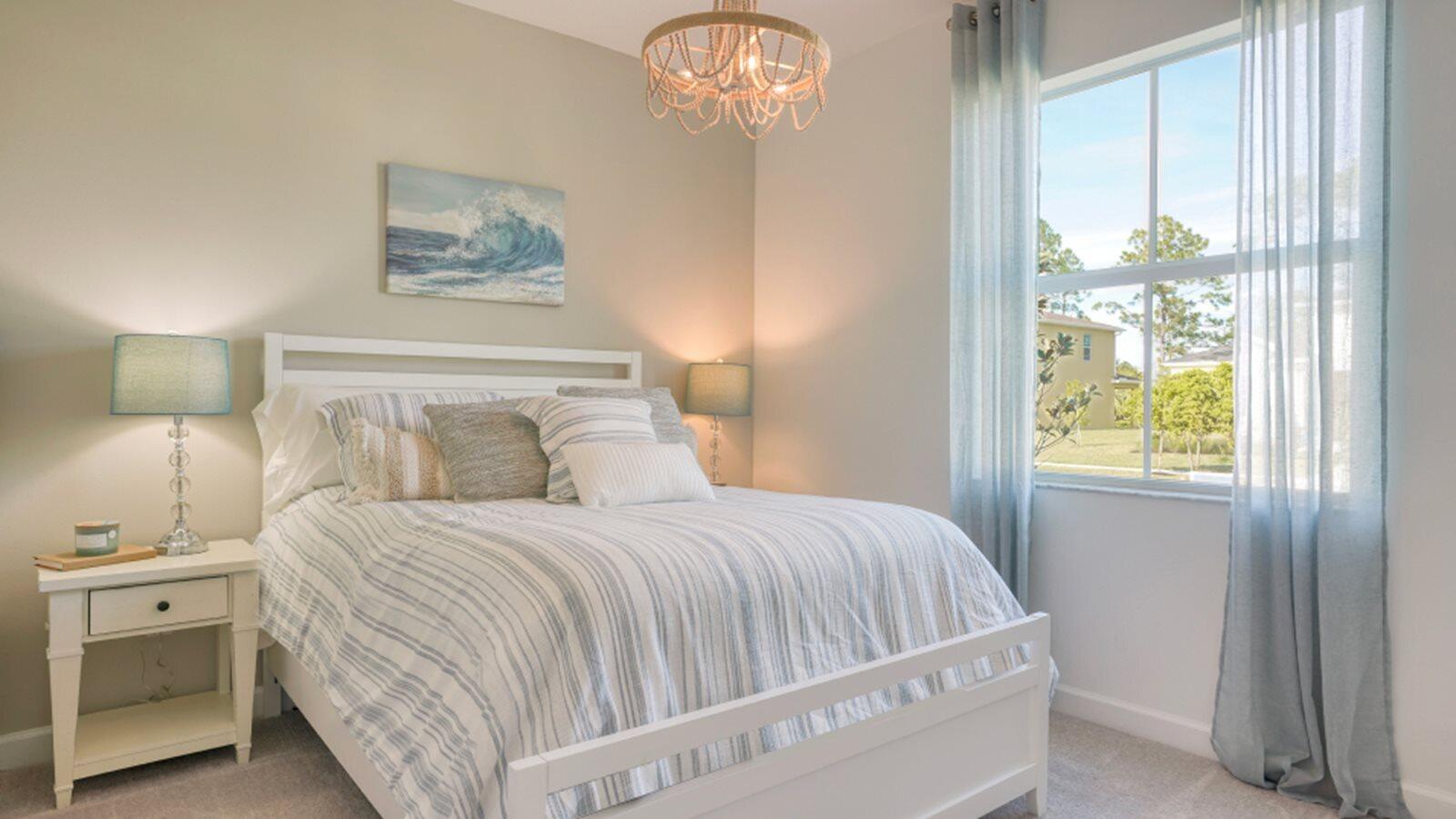 3611 Angler Drive Fort Pierce, FL 34946 - Photo 9 of 13 a bedroom with a bed and a chandelier