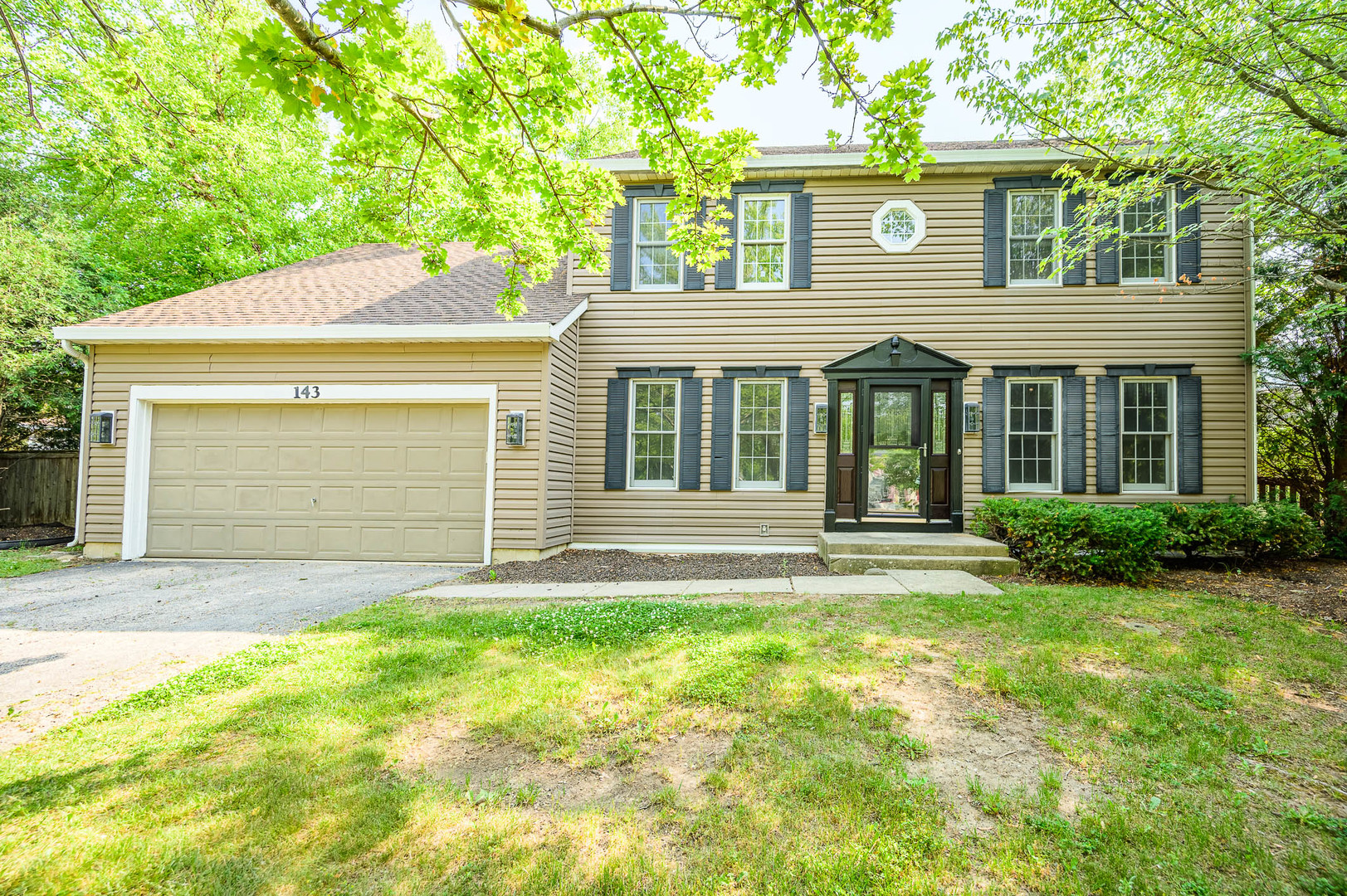 a front view of a house with a garden