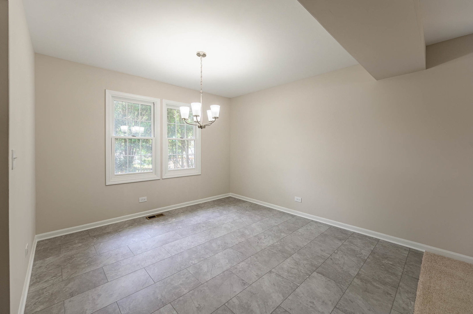 143 Hampton Street Cary, IL 60013 - Photo 3 of 19 an empty room with windows and chandelier fan