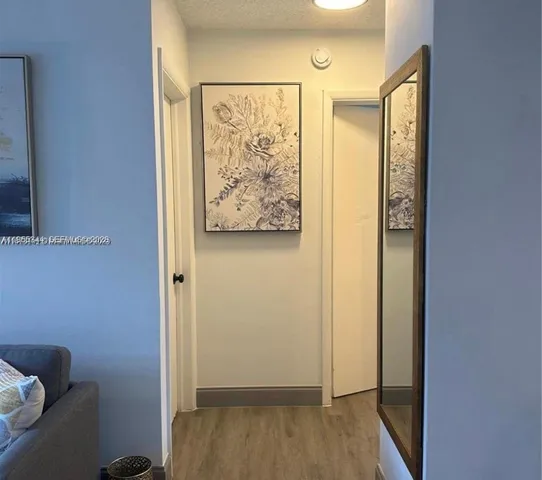 a view of front door with wooden floor