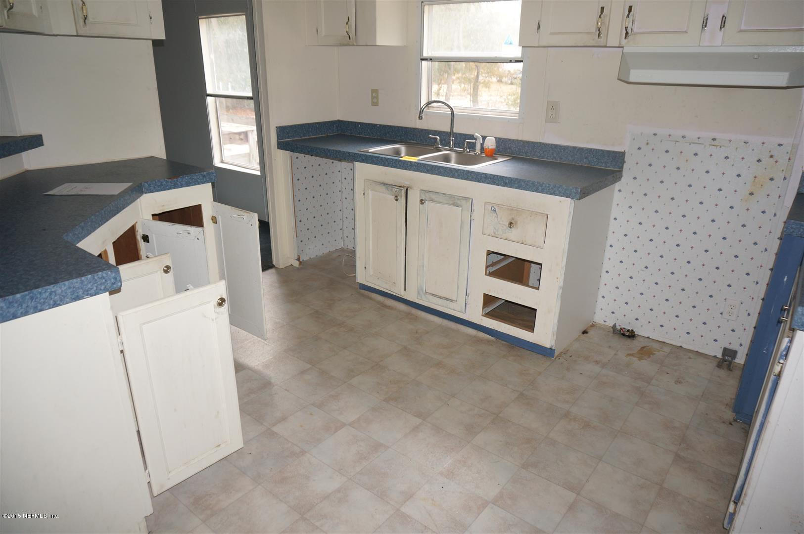 7463 Lilly Court Keystone Heights, FL 32656 - Photo 3 of 10 a kitchen with a sink and a stove top oven