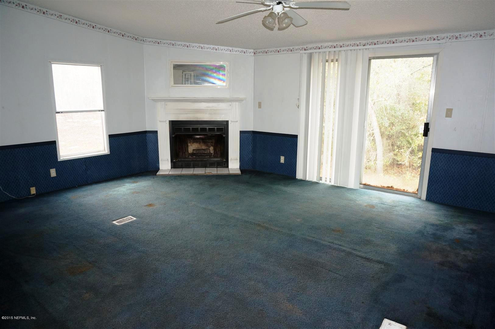 7463 Lilly Court Keystone Heights, FL 32656 - Photo 4 of 10 a view of empty room with fireplace and window