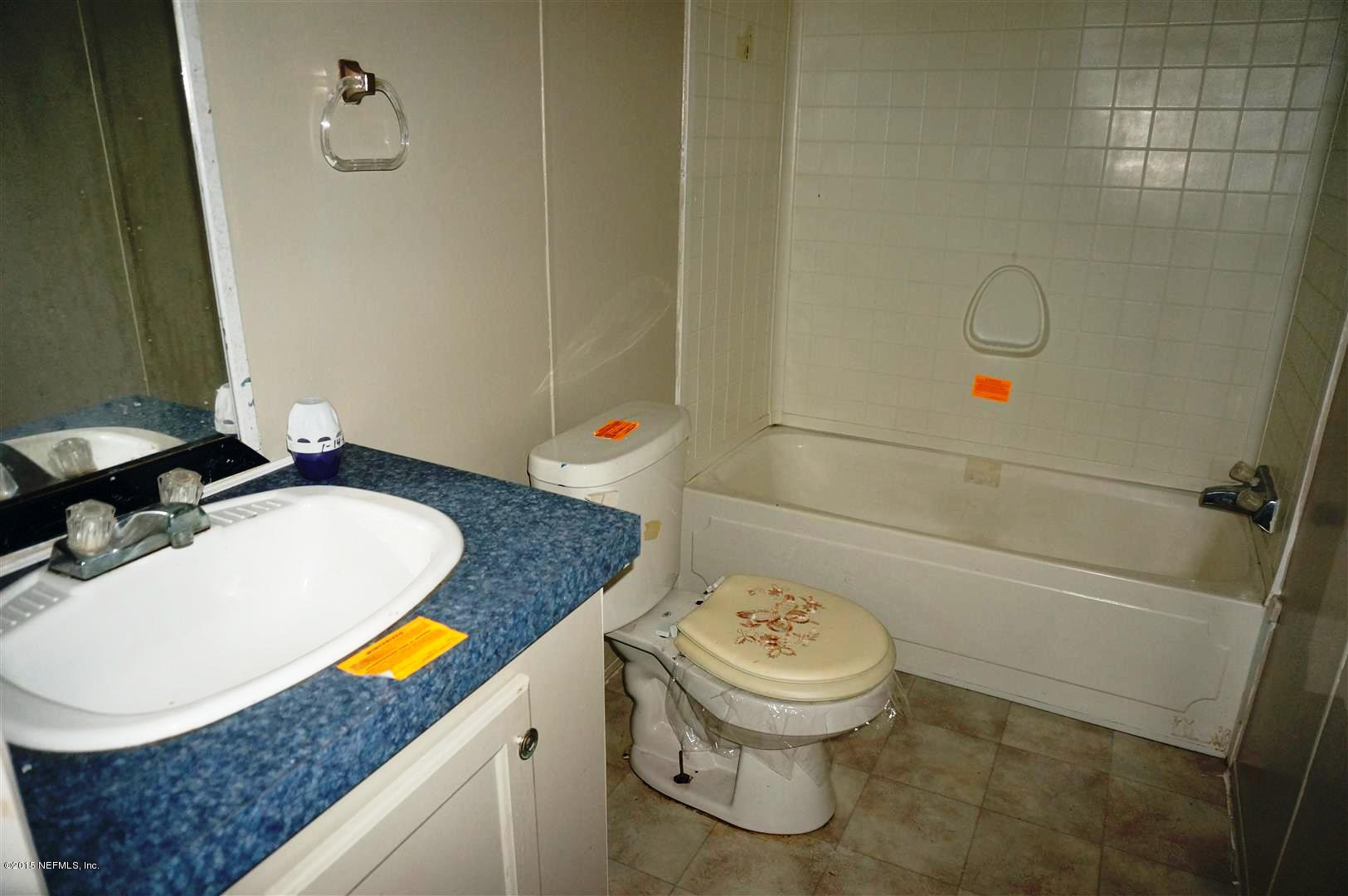 7463 Lilly Court Keystone Heights, FL 32656 - Photo 6 of 10 a bathroom with a granite countertop sink and a mirror