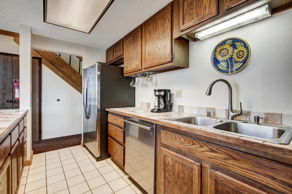 745 Columbine Road, Unit A404 Breckenridge, CO 80424 - Photo 13 of 32 a kitchen with a sink and a refrigerator