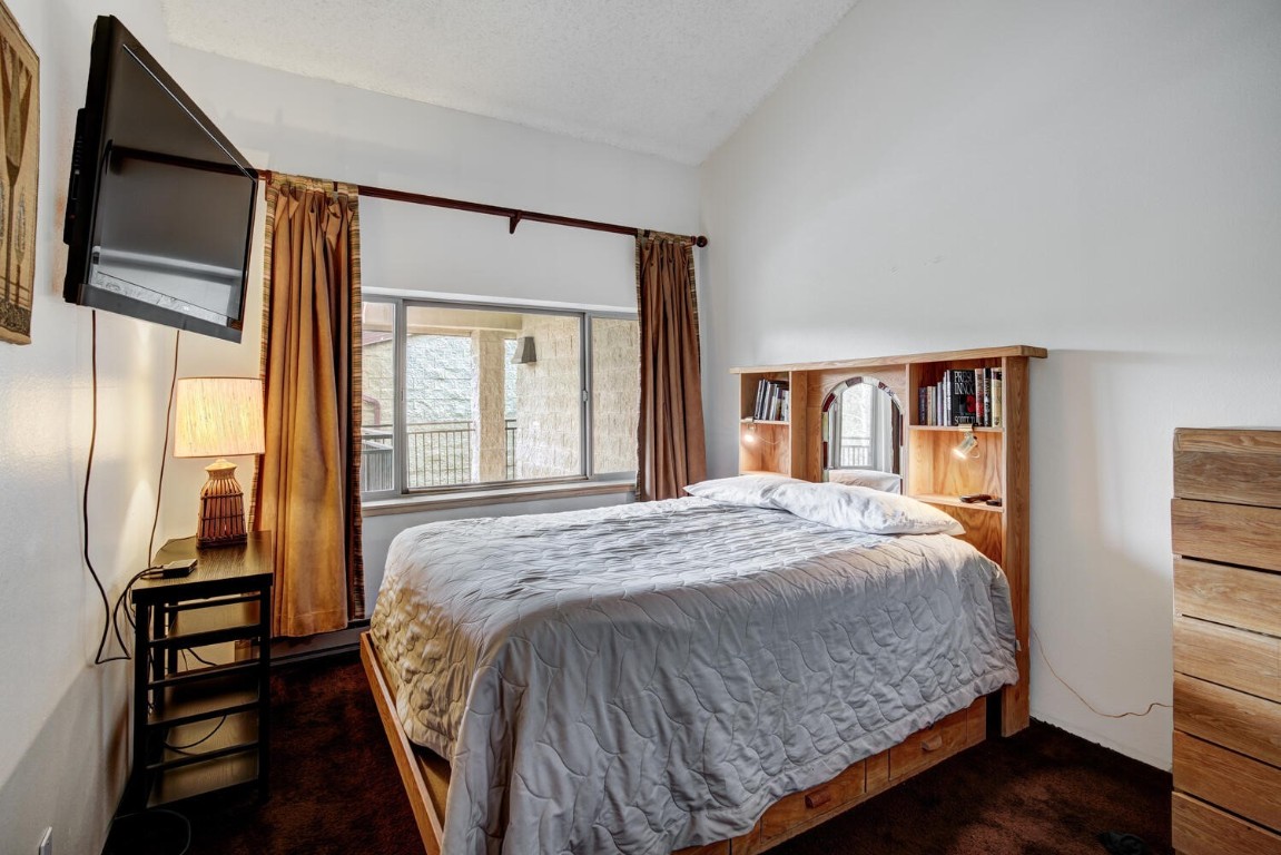 745 Columbine Road, Unit A404 Breckenridge, CO 80424 - Photo 14 of 32 a bedroom with a large bed and a large window