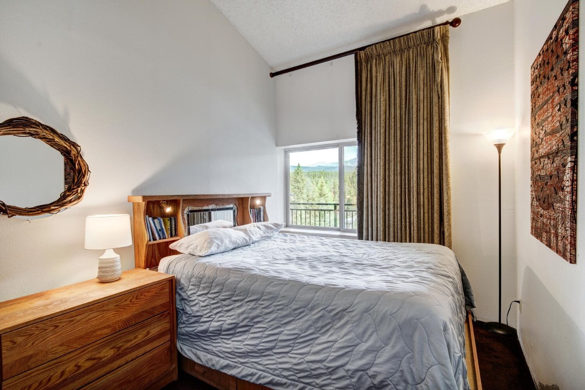 745 Columbine Road, Unit A404 Breckenridge, CO 80424 - Photo 16 of 32 a bedroom with a bed and a window