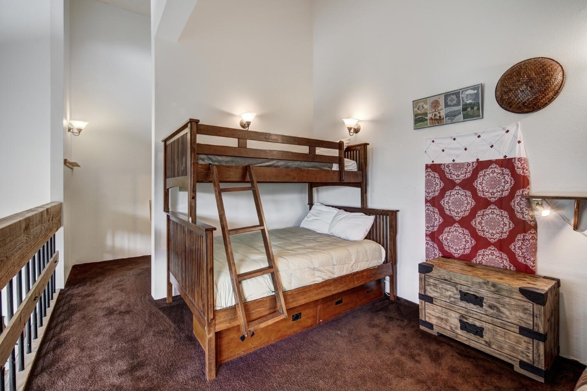 745 Columbine Road, Unit A404 Breckenridge, CO 80424 - Photo 18 of 32 a bedroom with a bed and a window