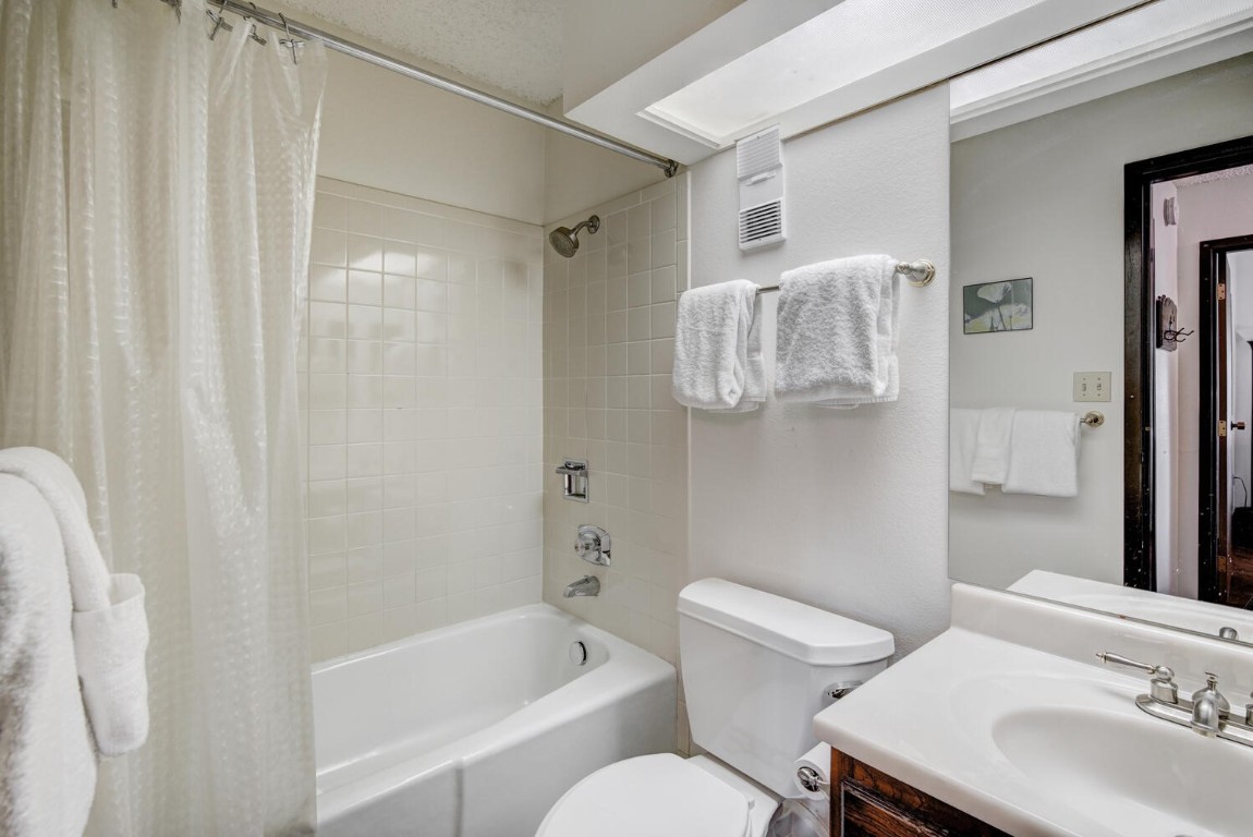 745 Columbine Road, Unit A404 Breckenridge, CO 80424 - Photo 20 of 32 a bathroom with a sink toilet and shower