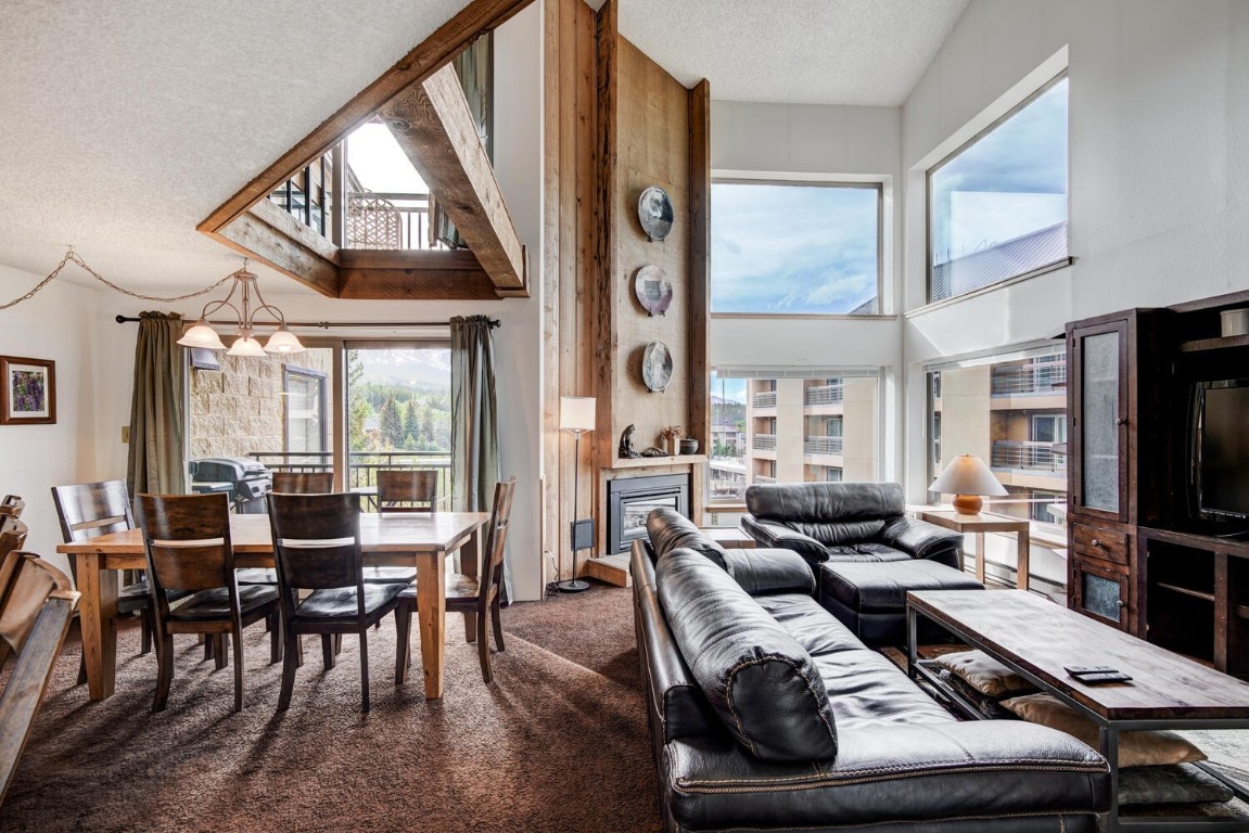745 Columbine Road, Unit A404 Breckenridge, CO 80424 - Photo 6 of 32 a living room with furniture and a flat screen tv