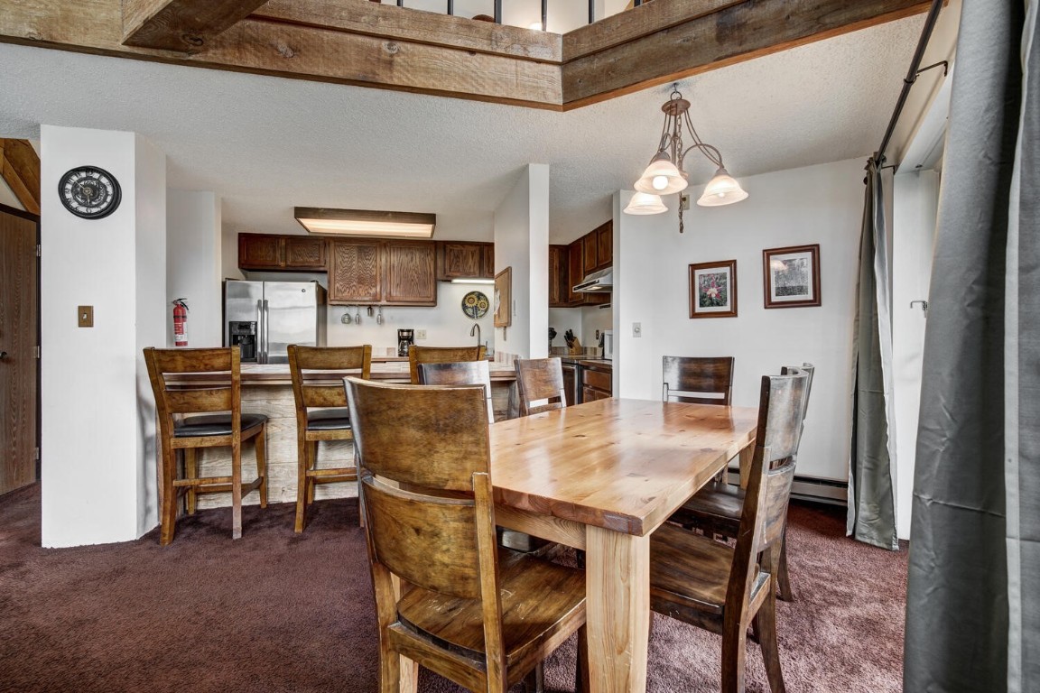 745 Columbine Road, Unit A404 Breckenridge, CO 80424 - Photo 9 of 32 a dining room with furniture and window