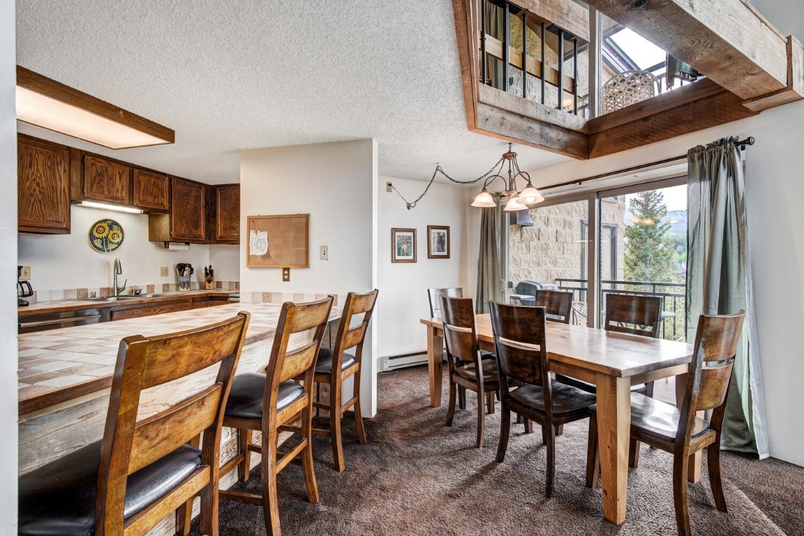 745 Columbine Road, Unit A404 Breckenridge, CO 80424 - Photo 10 of 32 a view of a dining room with furniture and a kitchen