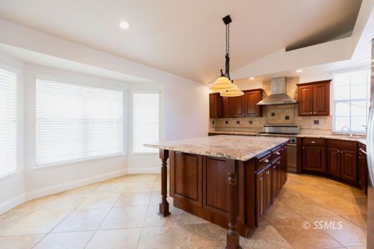 919 Beverly Court Ridgecrest, CA 93555 - Photo 12 of 29 a kitchen with a stove sink and cabinets
