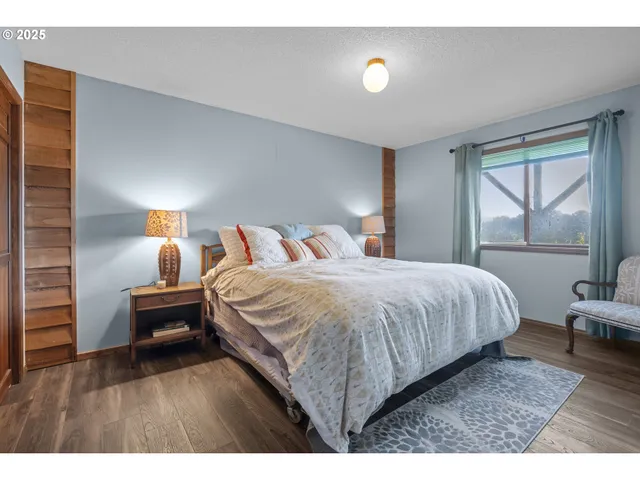 a bedroom with a bed and a night stand