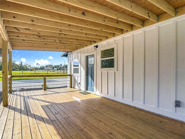a view of swimming pool with wooden floor and seating space