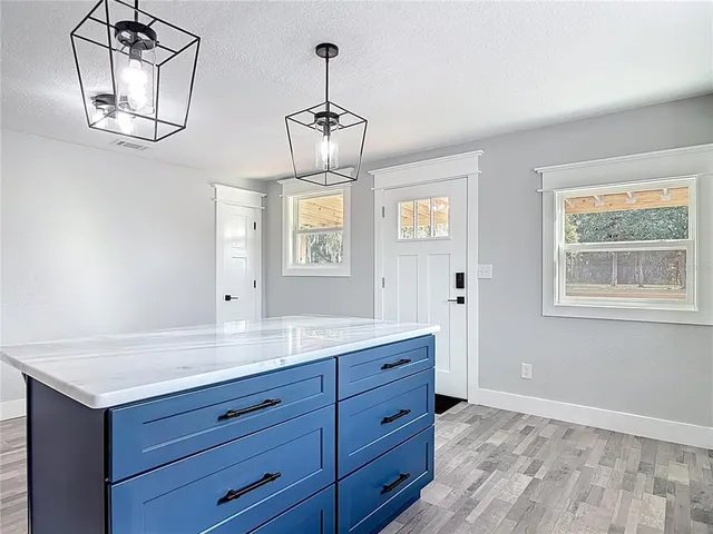 a kitchen with stainless steel appliances a stove microwave and sink