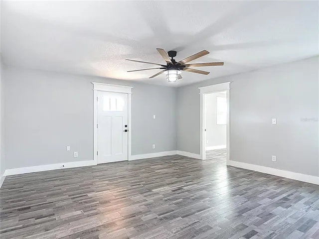 wooden floor in an empty room with a window