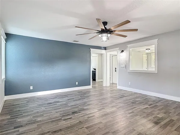 wooden floor in an empty room with a window