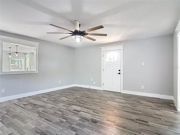 wooden floor in an empty room with a window