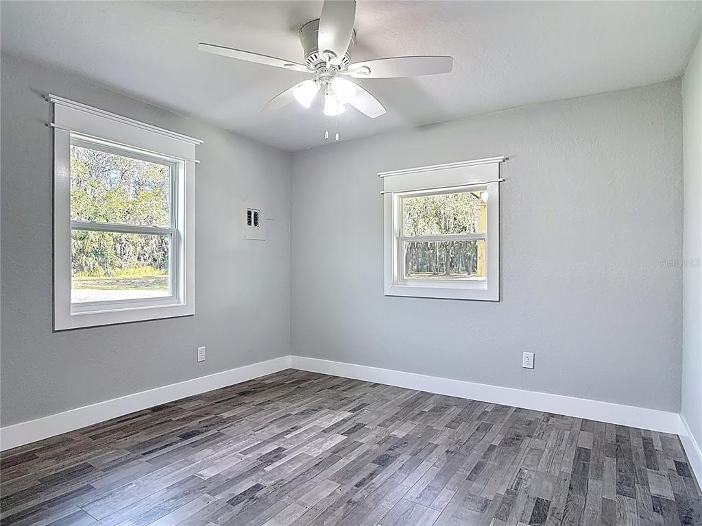 379 State Rte 415 Osteen, FL 32764 - Photo 29 of 48 wooden floor in an empty room with a window