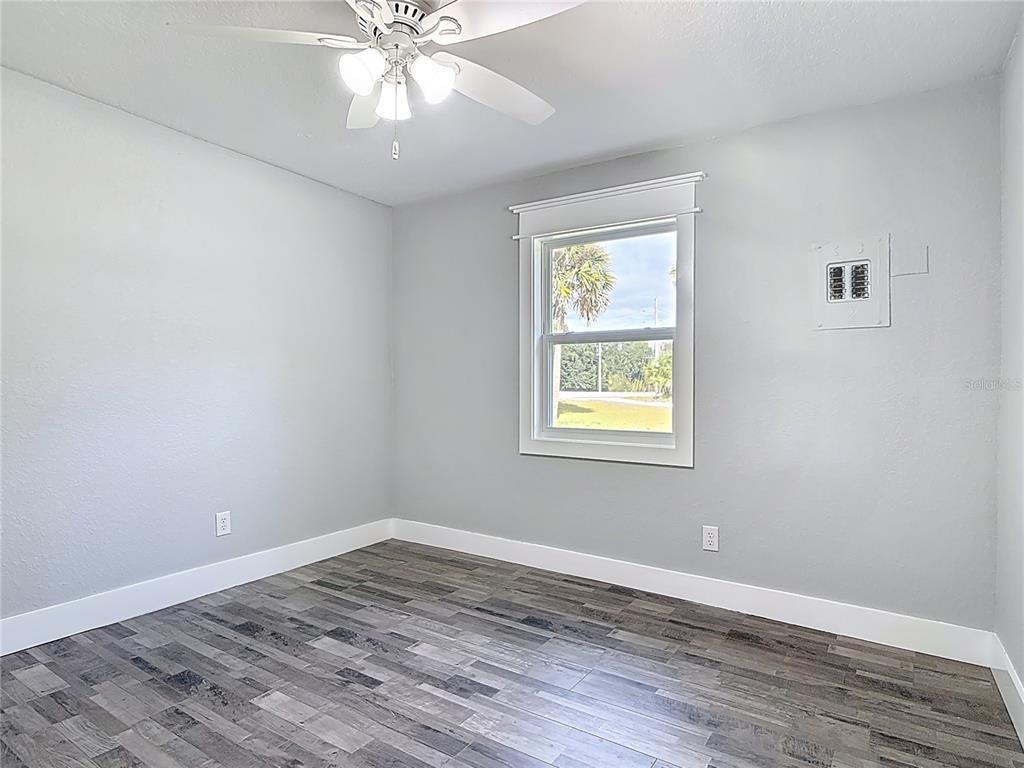 379 State Rte 415 Osteen, FL 32764 - Photo 30 of 48 wooden floor in an empty room with a window