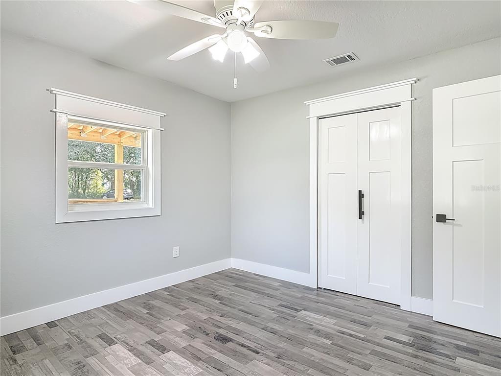 379 State Rte 415 Osteen, FL 32764 - Photo 32 of 48 a view of an empty room with wooden floor and a window