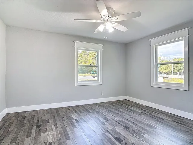 wooden floor in an empty room with a window