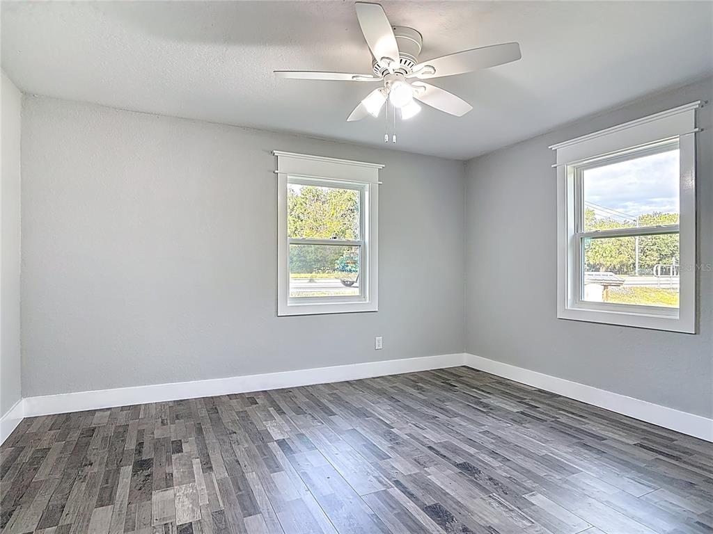 379 State Rte 415 Osteen, FL 32764 - Photo 33 of 48 a view of an empty room with wooden floor and a window